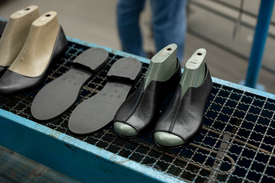 Craftsman making a leather shoe in a footwear workshop