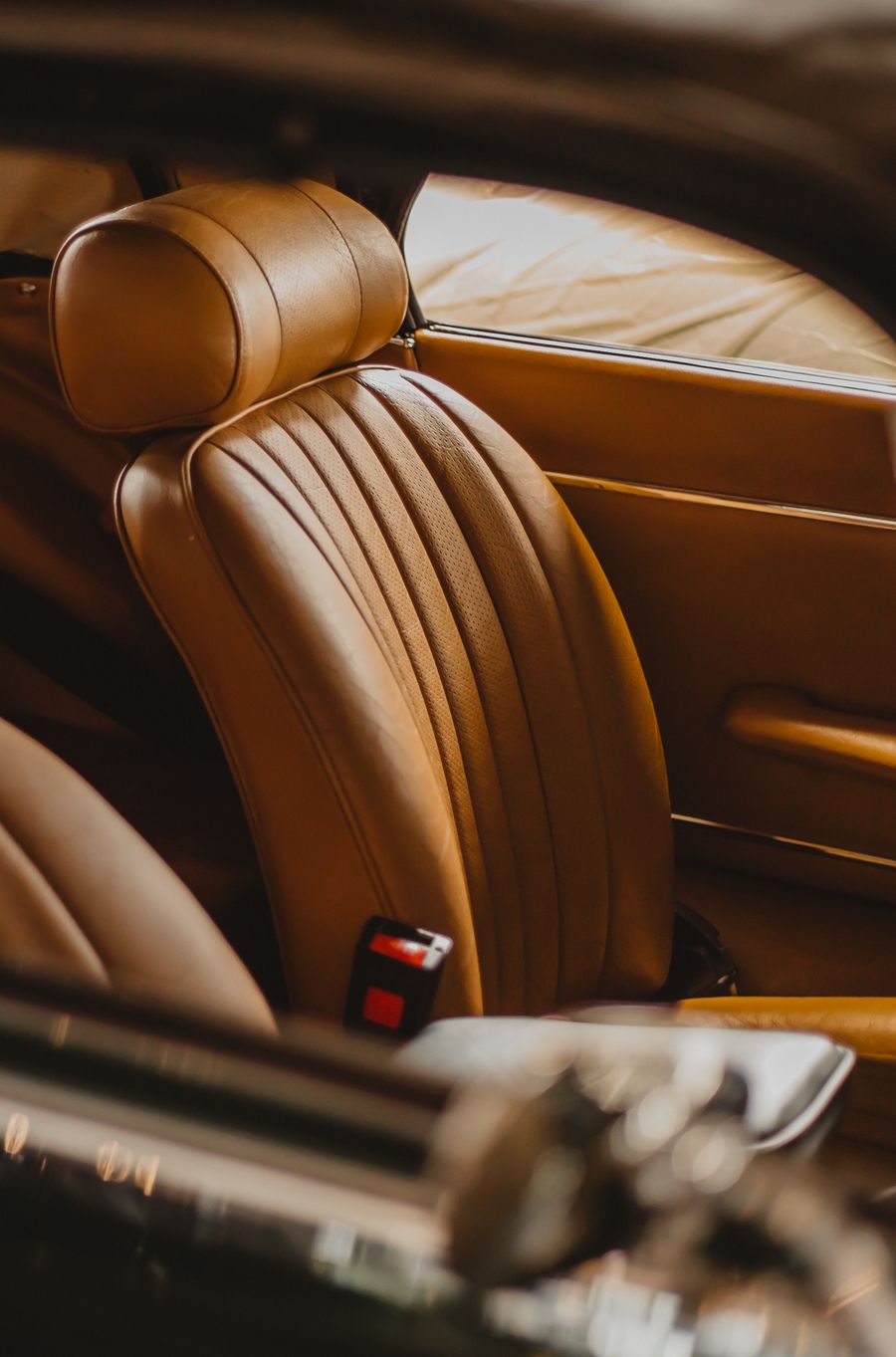 Tan foam-backed leather upholstery on a car seat